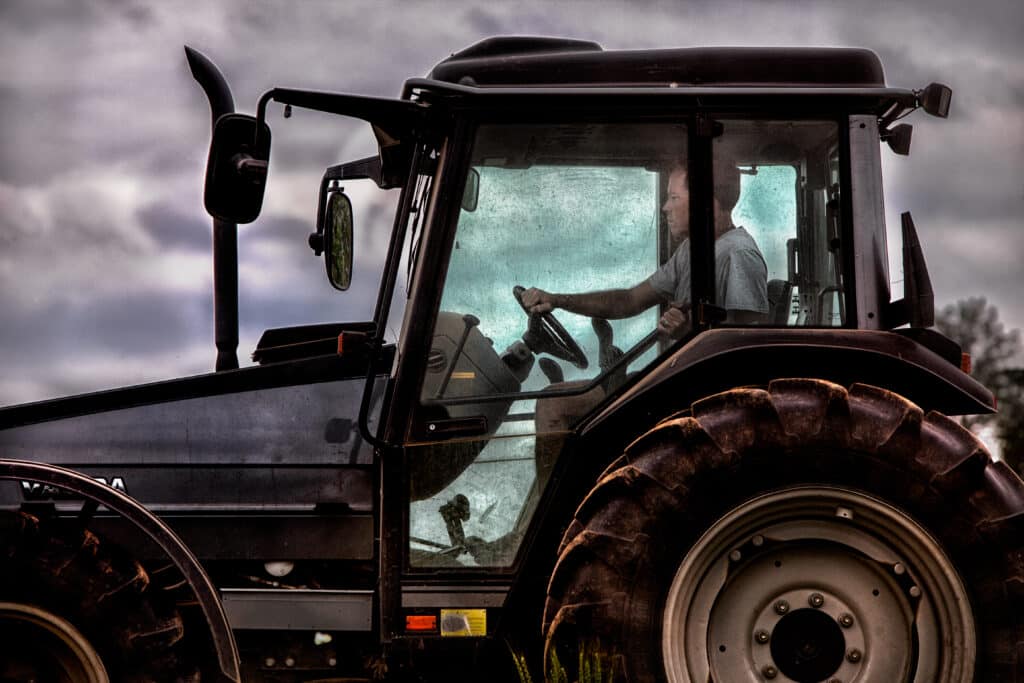 Farmer John Bell at Elmwood Stock Farm on a tractor
